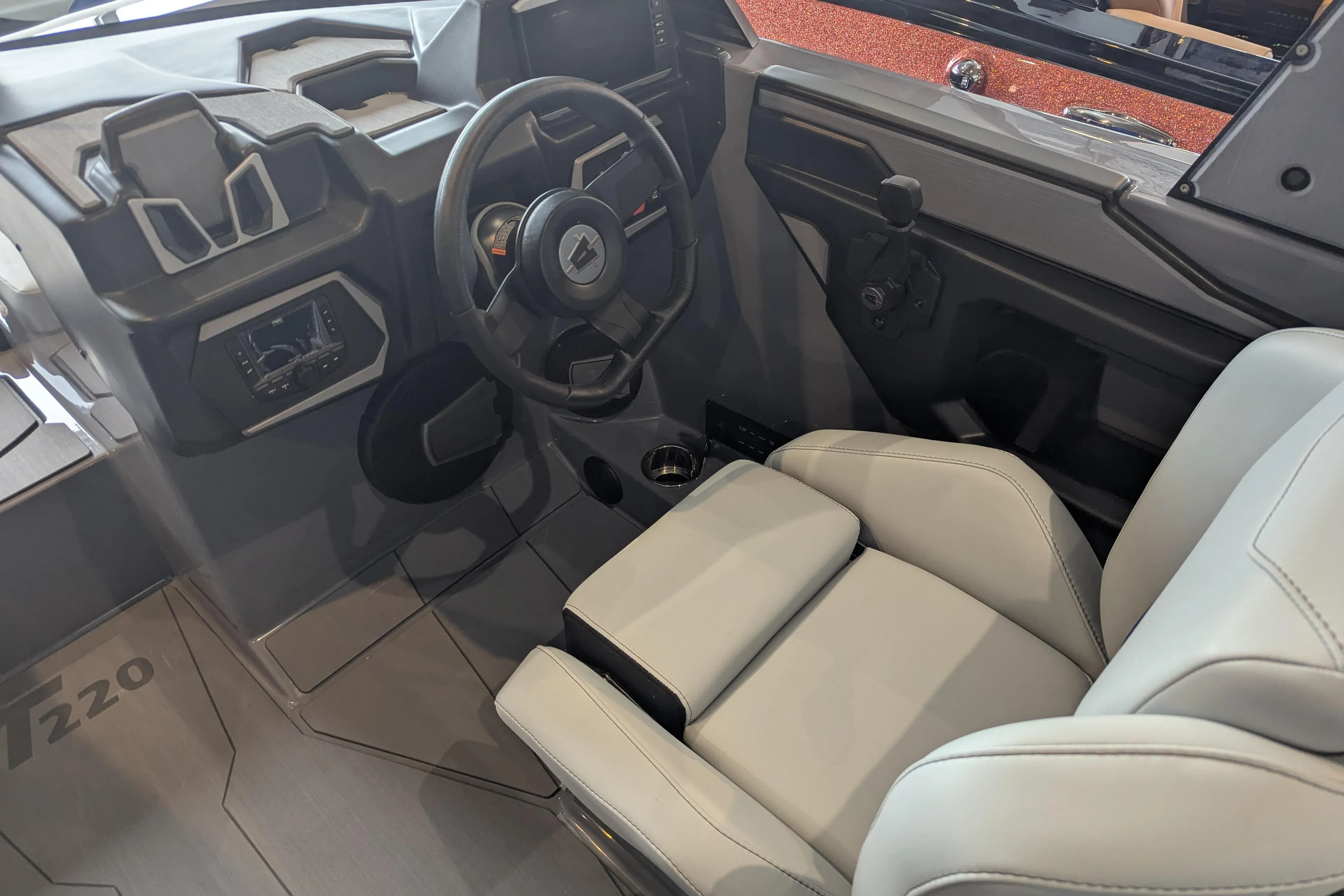 2025 Axis T220 boat interior with modern steering wheel and comfortable seating.