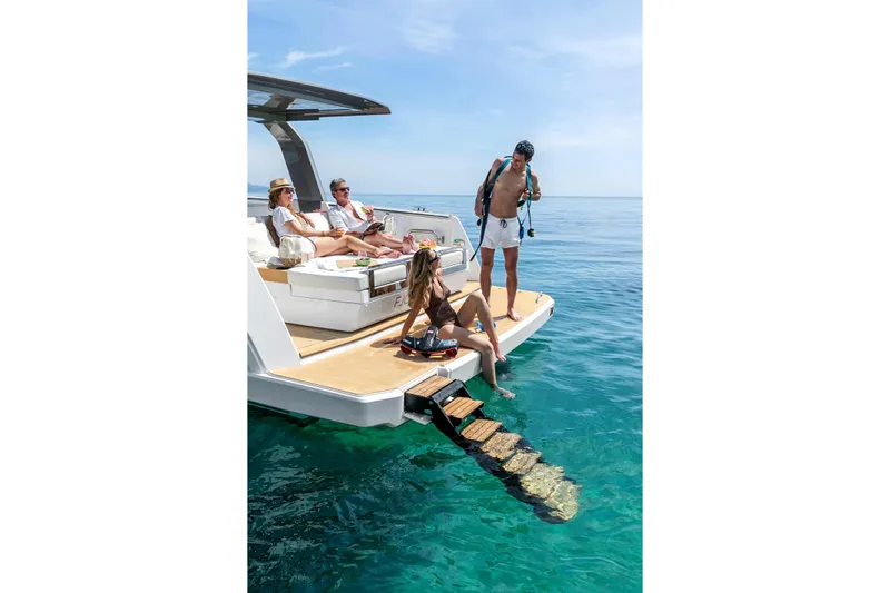  Yacht Photos Pics People relaxing on a 2025 Hanse Fjord 39 XL yacht in clear blue water.