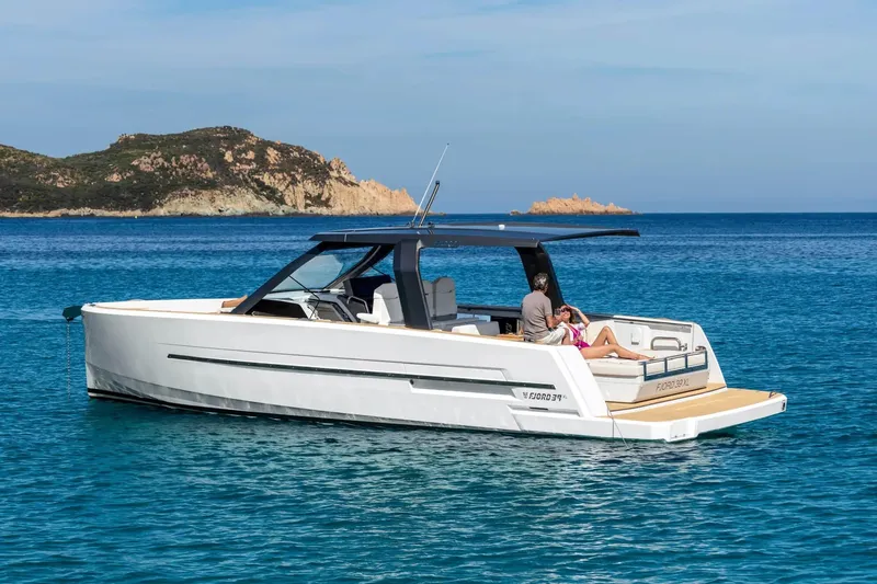  Yacht Photos Pics 2025 Hanse Fjord 39 XL yacht cruising in clear blue waters near rocky coastline.