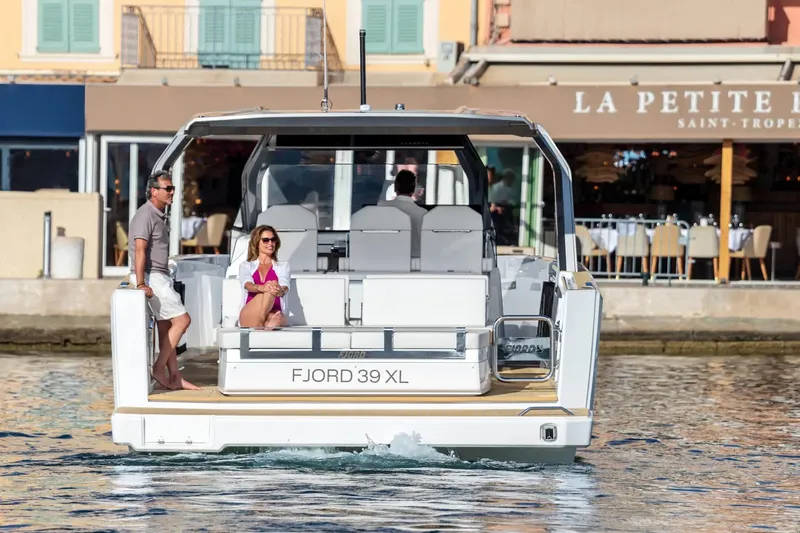  Yacht Photos Pics 2025 Hanse Fjord 39 XL yacht docked near a waterfront restaurant.