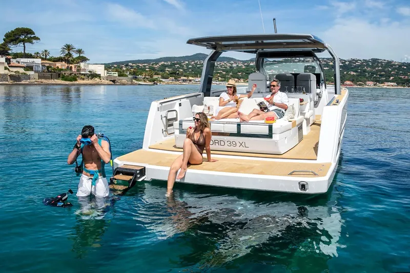  Yacht Photos Pics Luxury 2025 Hanse Fjord 39 XL yacht with people relaxing and swimming in clear blue water.