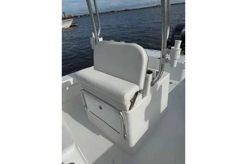  Yacht Photos Pics 2023 T Craft 27 boat seat with storage, on calm water background.