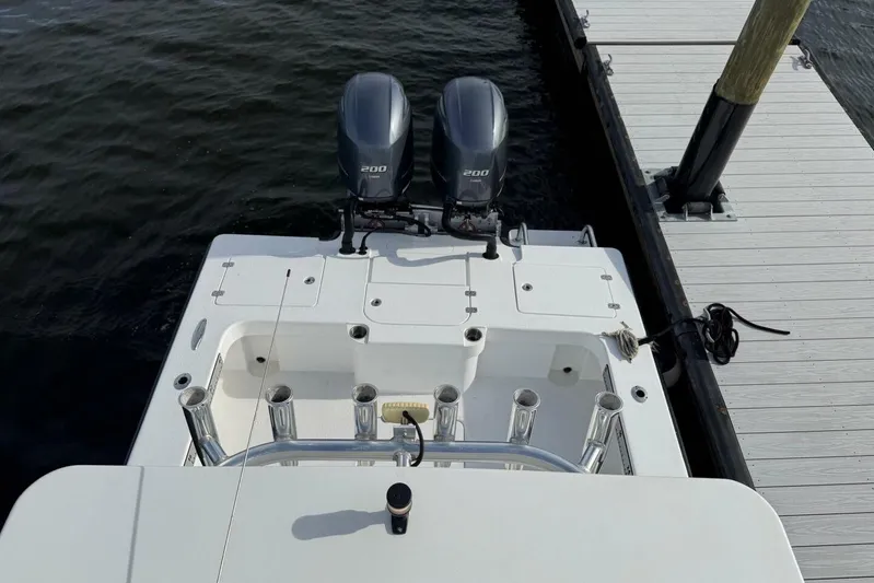  Yacht Photos Pics 2023 T Craft 27 boat with dual 200 horsepower engines docked at a marina.
