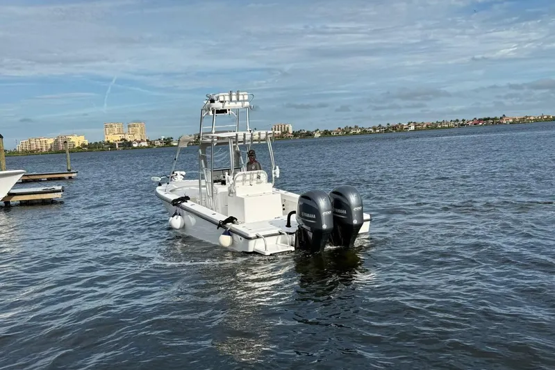  Yacht Photos Pics 2023 T Craft 27 boat with dual Yamaha engines on a calm waterway.