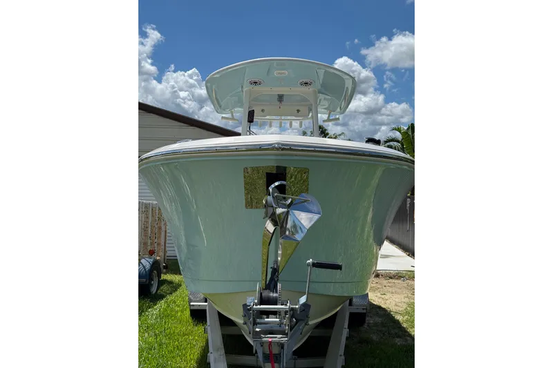  Yacht Photos Pics 2024 Cobia 280 Center Console boat on trailer under blue sky.