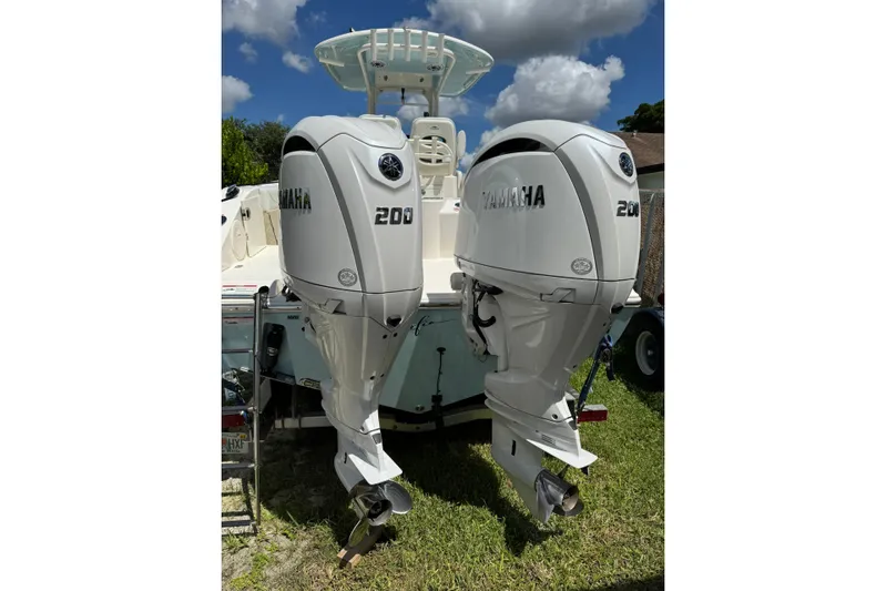  Yacht Photos Pics 2024 Cobia 280 Center Console with twin Yamaha 200 engines, parked on grass.