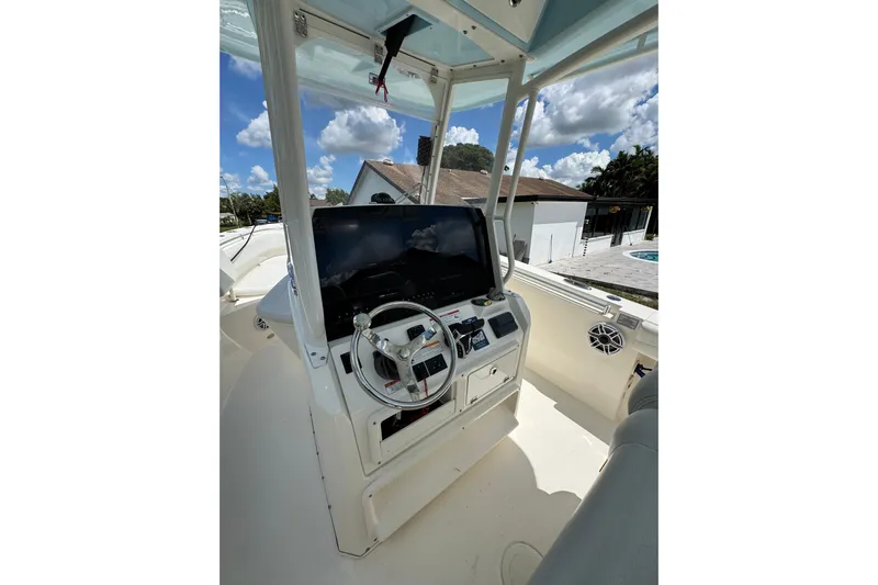  Yacht Photos Pics 2024 Cobia 280 Center Console boat interior with steering wheel and navigation display.