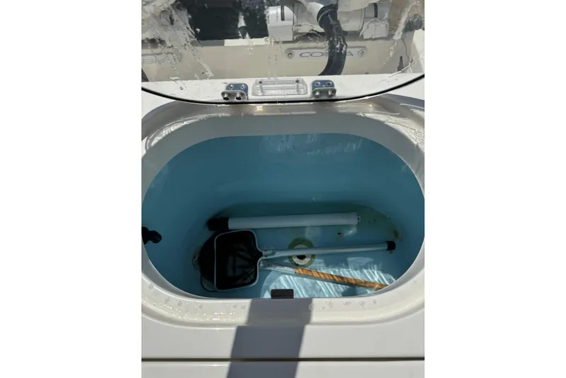  Yacht Photos Pics Livewell compartment in 2024 Cobia 280 Center Console boat, featuring fishing equipment.