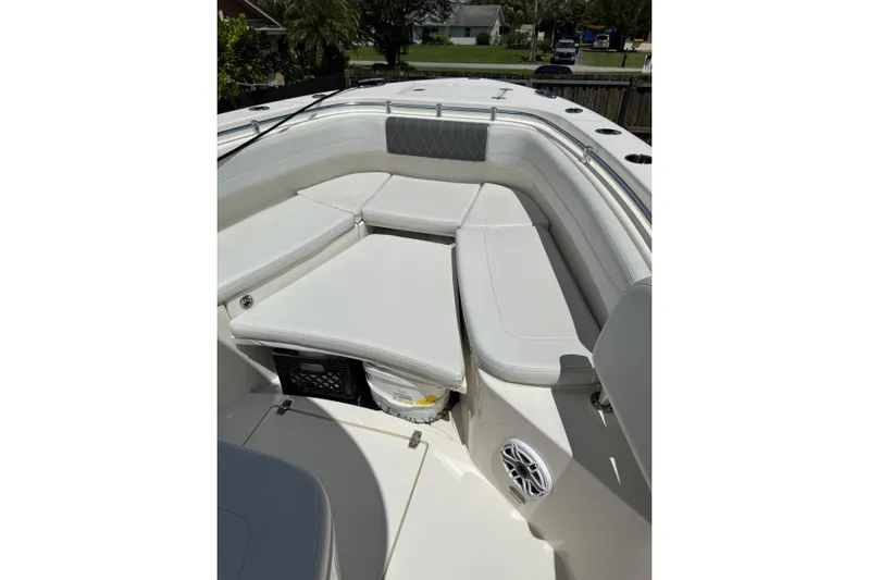  Yacht Photos Pics 2024 Cobia 280 Center Console boat interior with cushioned seating and storage.