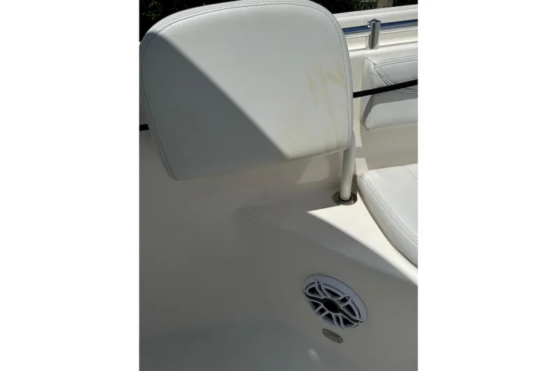 Yacht Photos Pics 2024 Cobia 280 Center Console boat interior with white seating and speaker detail.