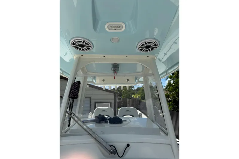  Yacht Photos Pics 2024 Cobia 280 Center Console boat interior with speakers and windshield view.