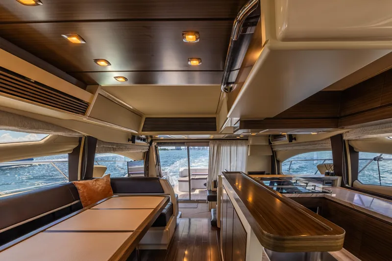 Prime Time II Yacht Photos Pics Luxurious interior of 2016 Azimut 64 Flybridge yacht with elegant wood finishes and ocean view.