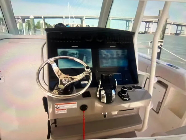  Yacht Photos Pics 2020 Boston Whaler 380 Outrage helm with dual screens and steering wheel.
