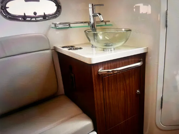  Yacht Photos Pics 2020 Boston Whaler 380 Outrage cabin interior with sink and seating.