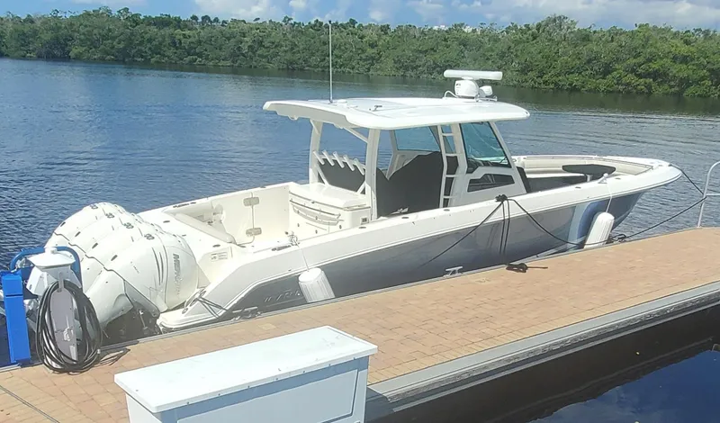  Yacht Photos Pics 2020 Boston Whaler 380 Outrage docked by a serene lake.