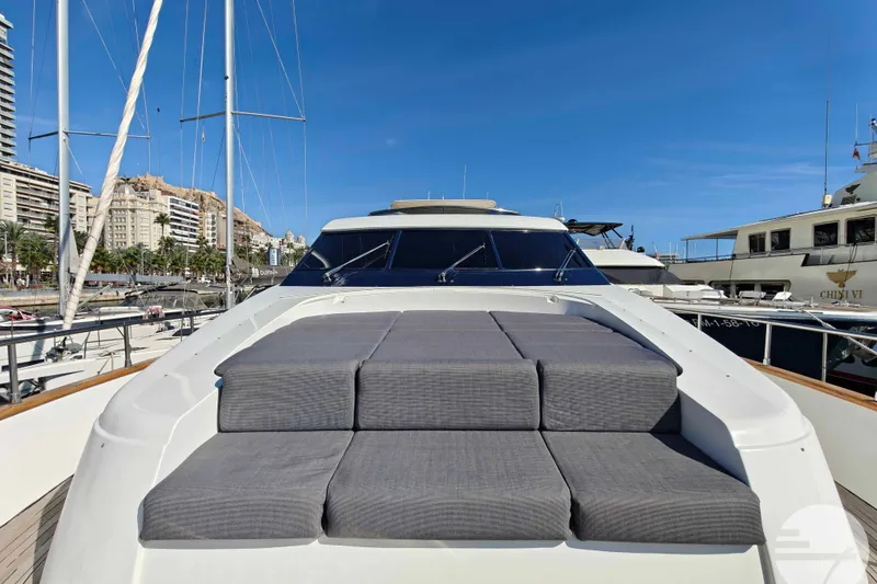 Yacht Photos Pics Luxurious 1999 Sanlorenzo SL82 yacht with sunbathing area, docked in a marina.