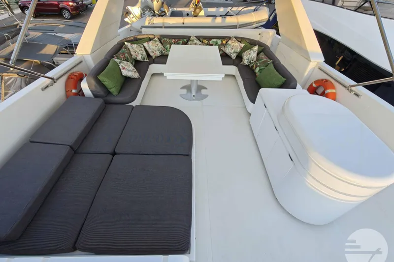  Yacht Photos Pics Luxurious seating area on 1999 Sanlorenzo SL82 yacht with cushions and table.