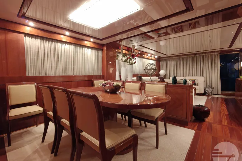 Yacht Photos Pics Luxurious dining area on 1999 Sanlorenzo SL82 yacht, featuring elegant wood finishes and ambient lighting.