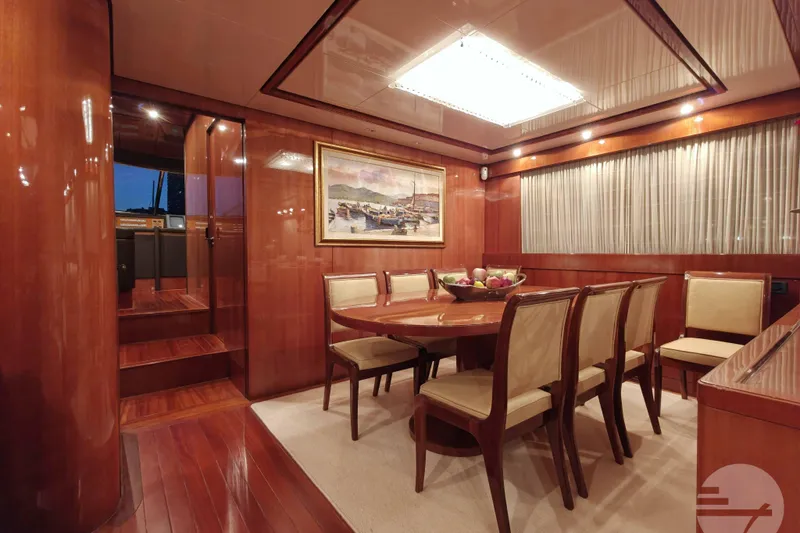  Yacht Photos Pics Luxurious dining area on 1999 Sanlorenzo SL82 yacht with elegant wood finishes.