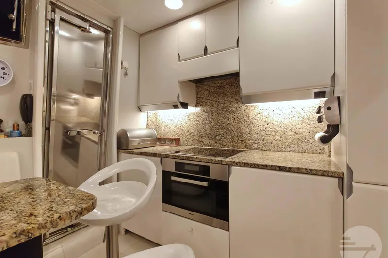  Yacht Photos Pics Luxurious 1999 Sanlorenzo SL82 yacht kitchen with modern appliances and granite countertops.