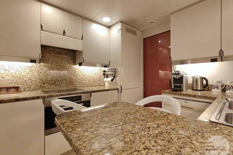  Yacht Photos Pics Luxurious kitchen interior on 1999 Sanlorenzo SL82 yacht with granite countertops and modern appliances.