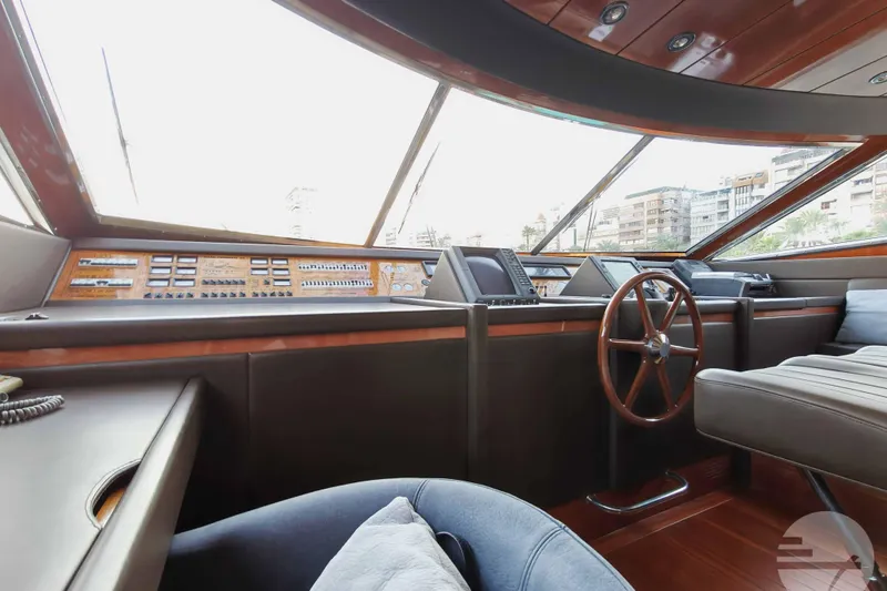  Yacht Photos Pics Luxurious 1999 Sanlorenzo SL82 yacht cockpit with wooden steering wheel and modern controls.