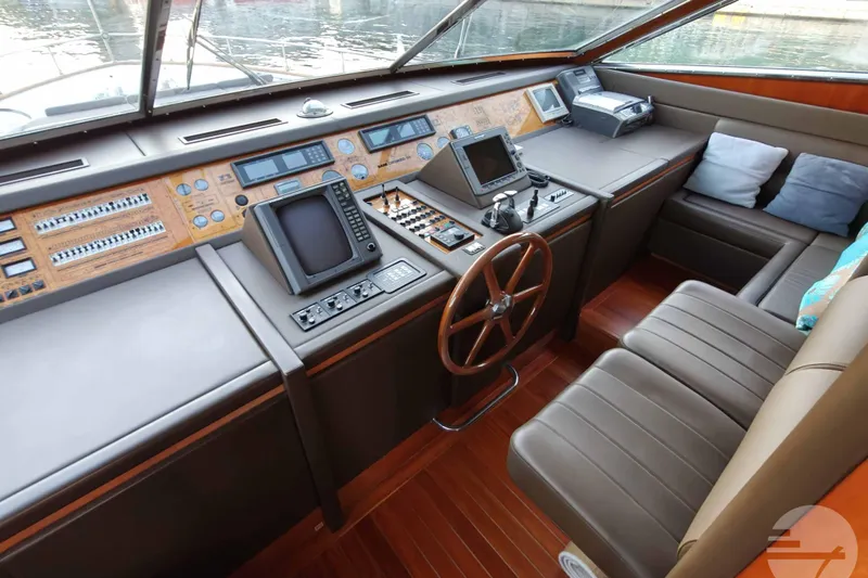  Yacht Photos Pics Cockpit of 1999 Sanlorenzo SL82 yacht with navigation equipment and leather seating.