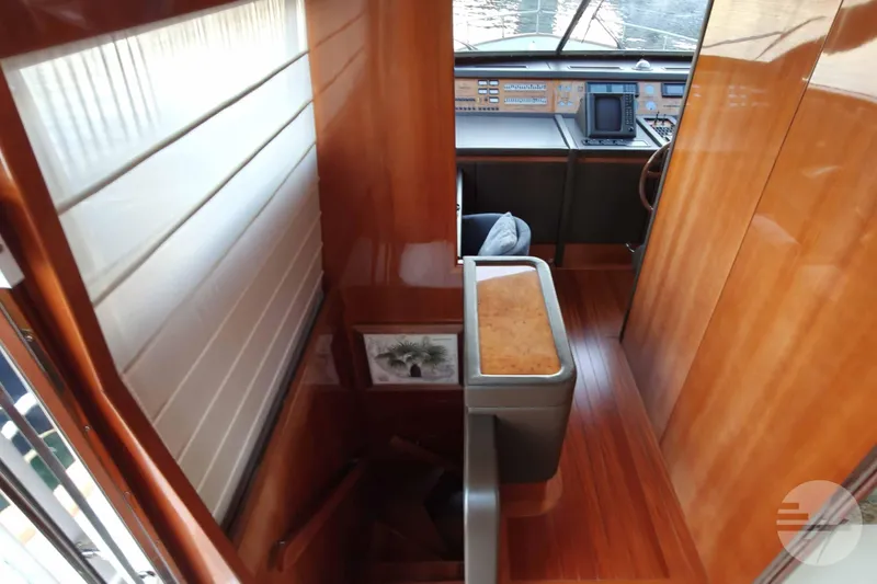  Yacht Photos Pics Interior view of 1999 Sanlorenzo SL82 yacht with wooden finishes and navigation area.