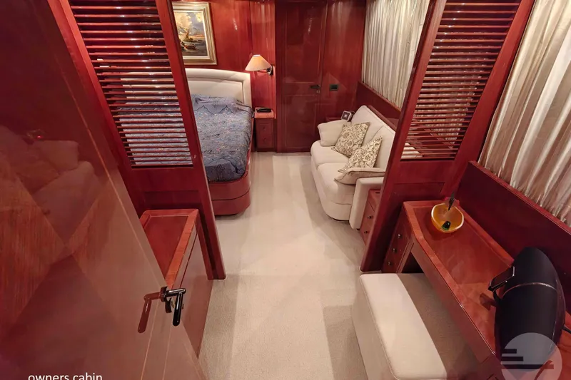  Yacht Photos Pics Luxurious owner's cabin in 1999 Sanlorenzo SL82 yacht with elegant wood finishes.