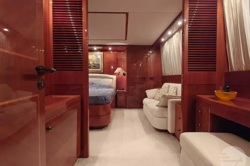  Yacht Photos Pics Luxurious interior of 1999 Sanlorenzo SL82 yacht with elegant wood finishes and cozy seating.