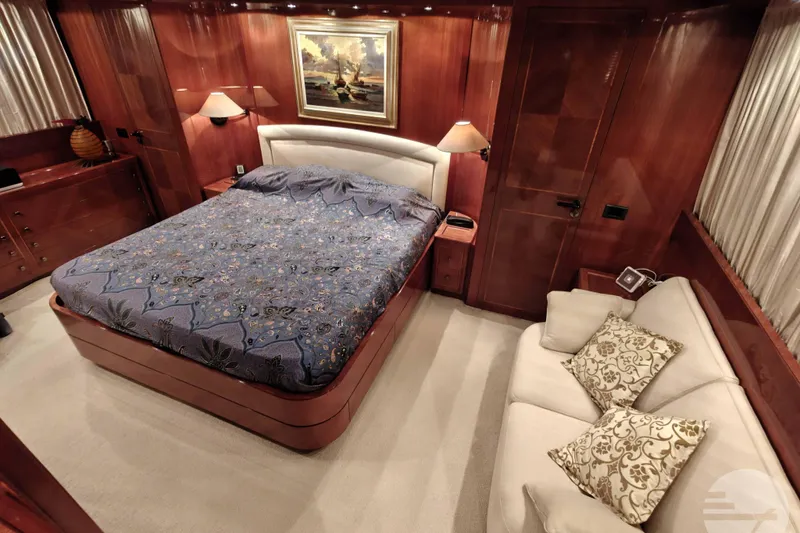  Yacht Photos Pics Luxurious Sanlorenzo SL82 1999 yacht bedroom with elegant wood paneling and cozy furnishings.