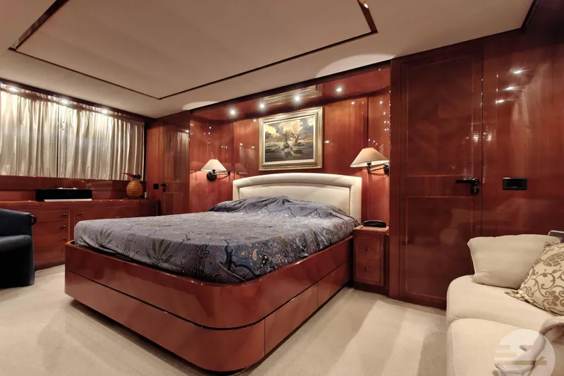  Yacht Photos Pics Luxurious bedroom interior of 1999 Sanlorenzo SL82 yacht with elegant wood paneling.