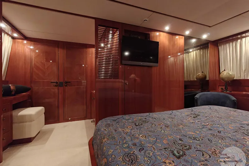  Yacht Photos Pics Luxurious cabin interior of 1999 Sanlorenzo SL82 yacht with elegant wood finishes.