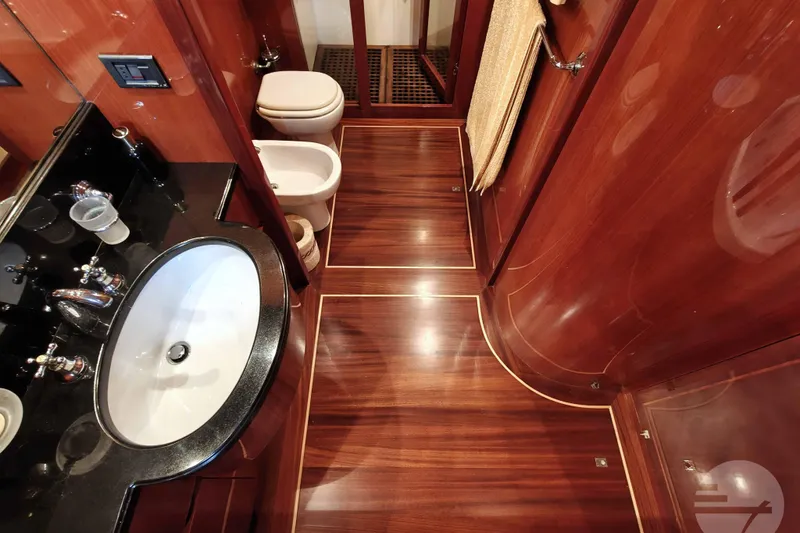  Yacht Photos Pics Luxurious bathroom interior of 1999 Sanlorenzo SL82 yacht with wood finish and modern fixtures.
