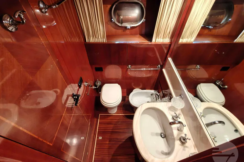  Yacht Photos Pics Luxurious bathroom in 1999 Sanlorenzo SL82 yacht with wood paneling and elegant fixtures.