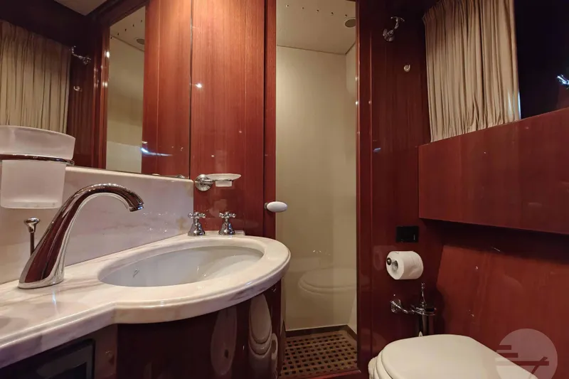  Yacht Photos Pics Luxurious bathroom in 1999 Sanlorenzo SL82 yacht with wood paneling and modern fixtures.