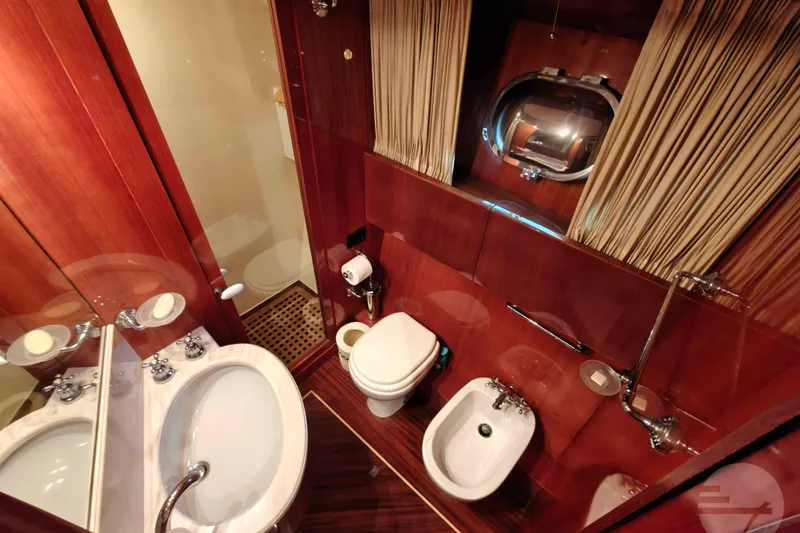  Yacht Photos Pics Luxurious bathroom on 1999 Sanlorenzo SL82 yacht with wood accents and modern fixtures.