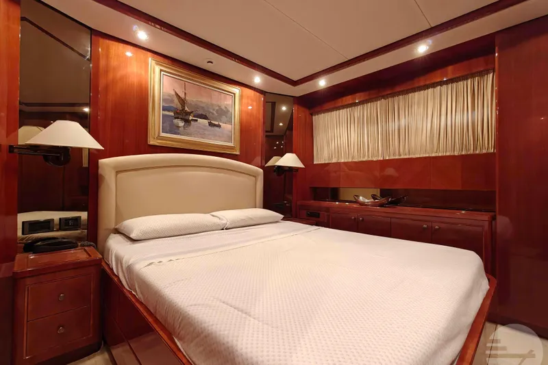  Yacht Photos Pics Luxurious bedroom interior of 1999 Sanlorenzo SL82 yacht with elegant wood paneling.