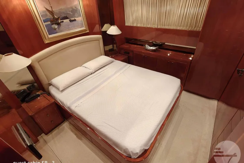  Yacht Photos Pics Luxurious guest cabin on 1999 Sanlorenzo SL82 yacht with elegant wood finishes.