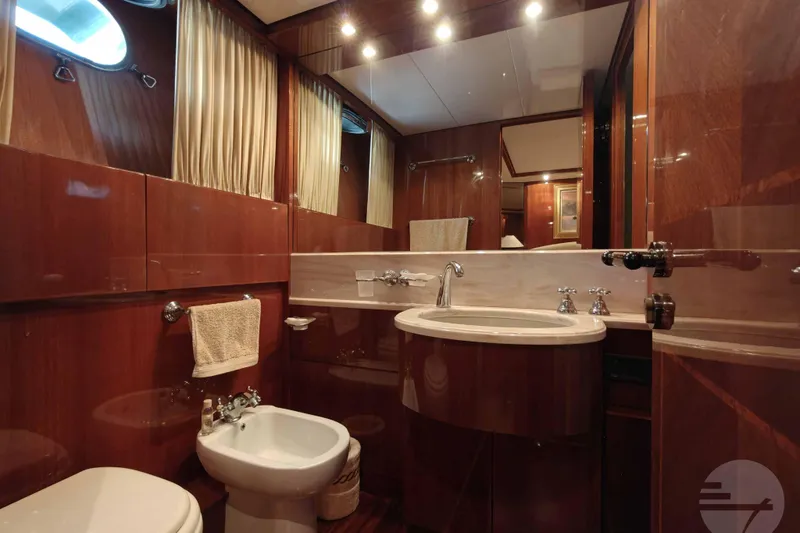  Yacht Photos Pics Luxurious bathroom on a 1999 Sanlorenzo SL82 yacht with wood paneling and elegant fixtures.
