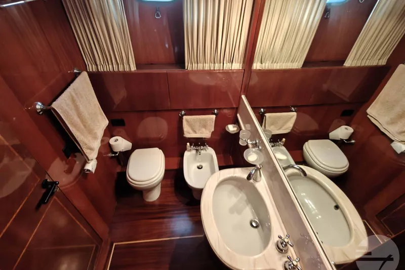  Yacht Photos Pics Luxurious bathroom on 1999 Sanlorenzo SL82 yacht with dual sinks and wooden accents.