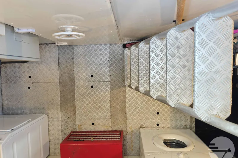  Yacht Photos Pics Engine room of 1999 Sanlorenzo SL82 yacht with metal stairs and machinery.