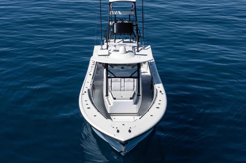  Yacht Photos Pics 2025 Yellowfin 42 Offshore boat on calm blue water, aerial view.