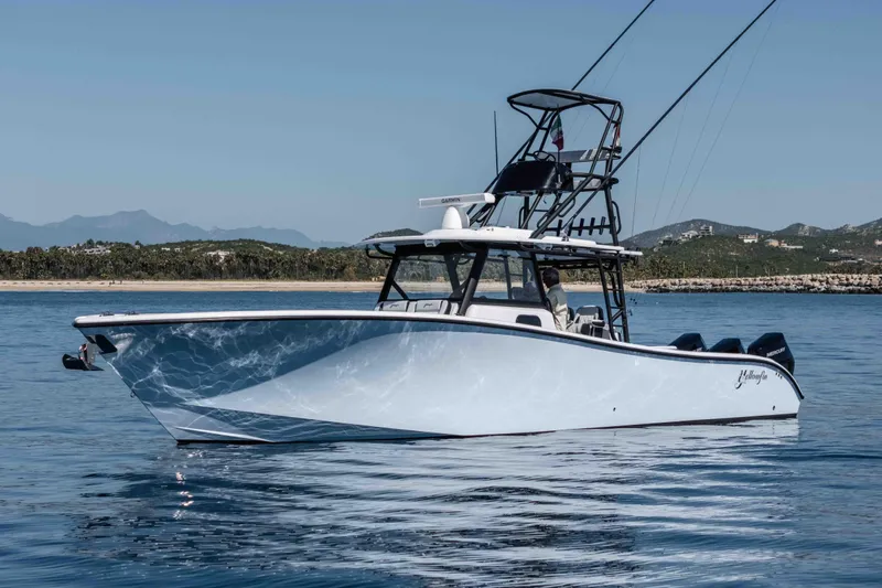  Yacht Photos Pics 2025 Yellowfin 42 Offshore boat on calm water, featuring sleek design and advanced fishing equipment.