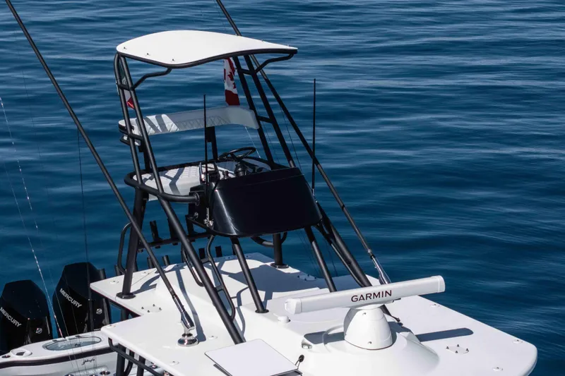  Yacht Photos Pics 2025 Yellowfin 42 Offshore boat with tower and Garmin equipment on calm blue water.