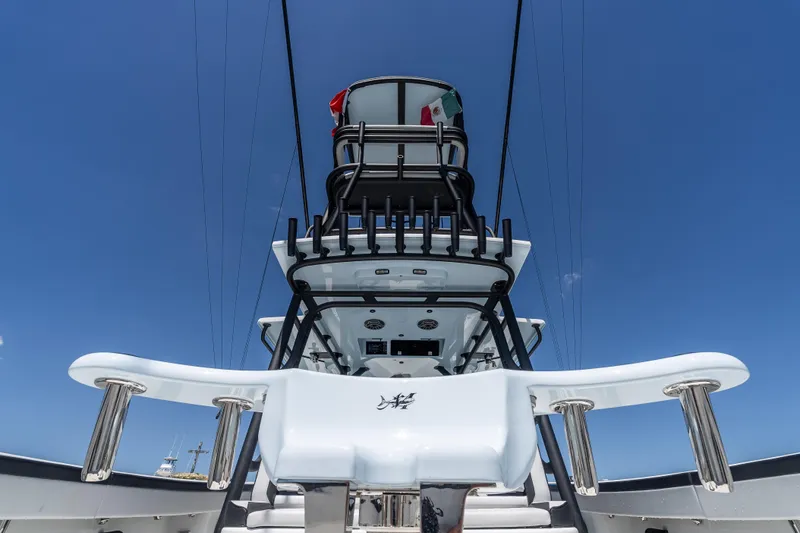  Yacht Photos Pics 2025 Yellowfin 42 Offshore boat, sleek design, viewed from below against clear blue sky.