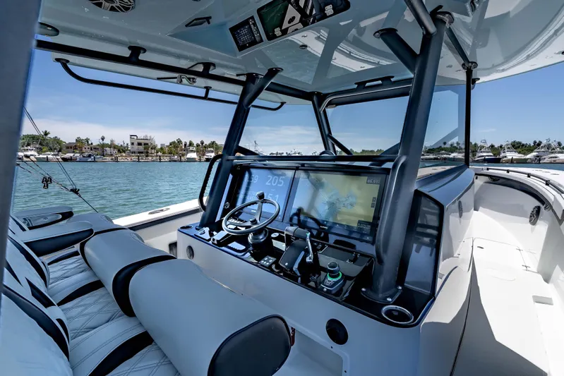  Yacht Photos Pics 2025 Yellowfin 42 Offshore boat cockpit with advanced navigation system and luxurious seating.