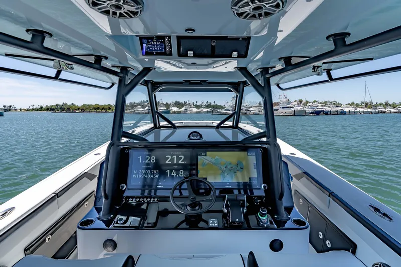 Yacht Photos Pics 2025 Yellowfin 42 Offshore boat cockpit with advanced navigation system on open water.