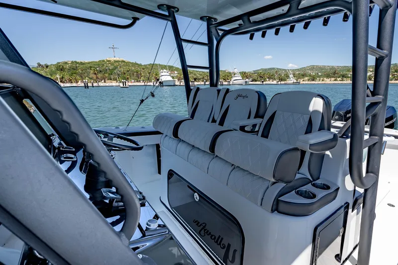  Yacht Photos Pics 2025 Yellowfin 42 Offshore boat interior with luxurious seating and scenic waterfront view.