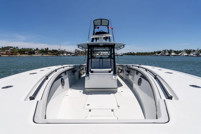  Yacht Photos Pics 2025 Yellowfin 42 Offshore boat on calm water, clear sky background.
